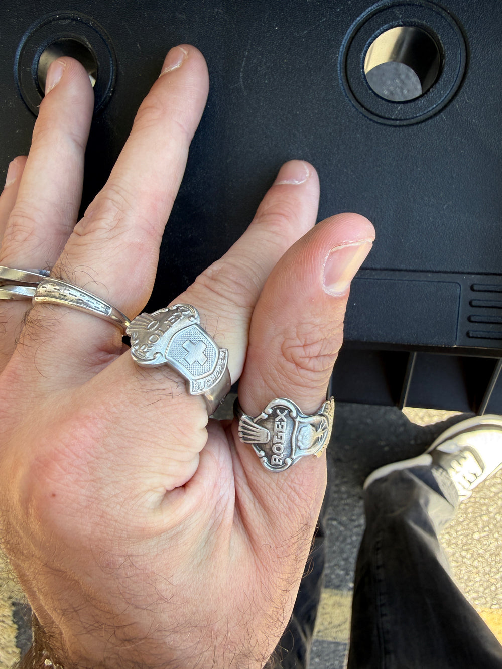 Handmade spoon rings worn on a hand